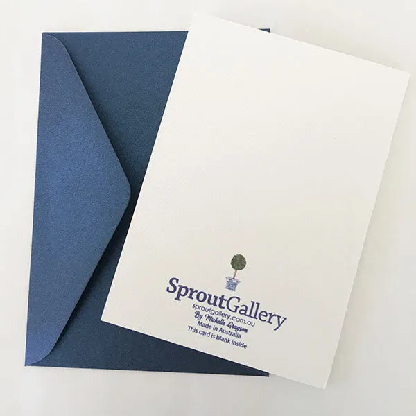 A blue and white card with topiary trees